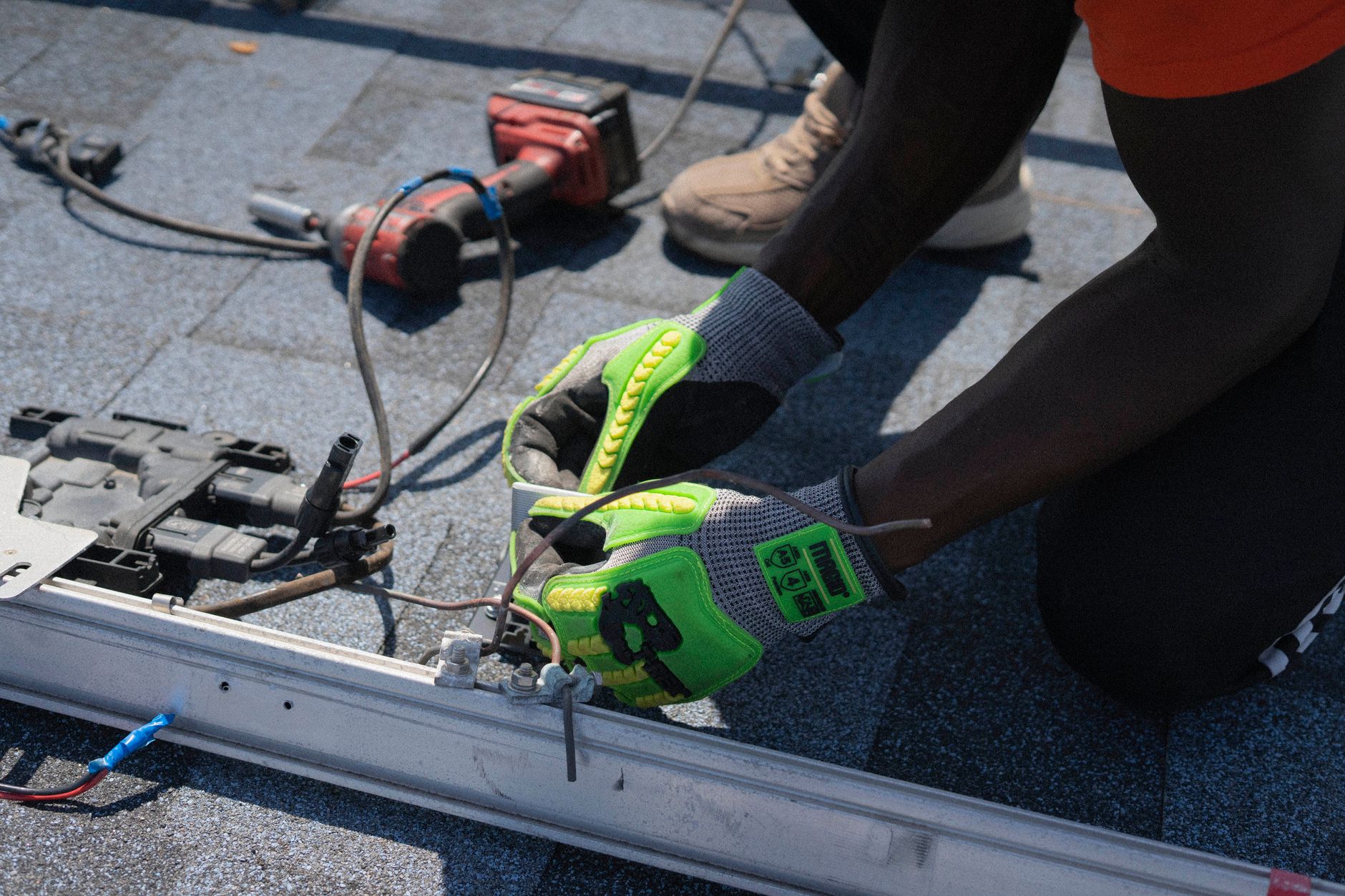 A skilled Storm Guard Roofing technician inspecting the flashing around a chimney on a tile roof in Paradise, Nevada, ensuring no water intrusion points.
