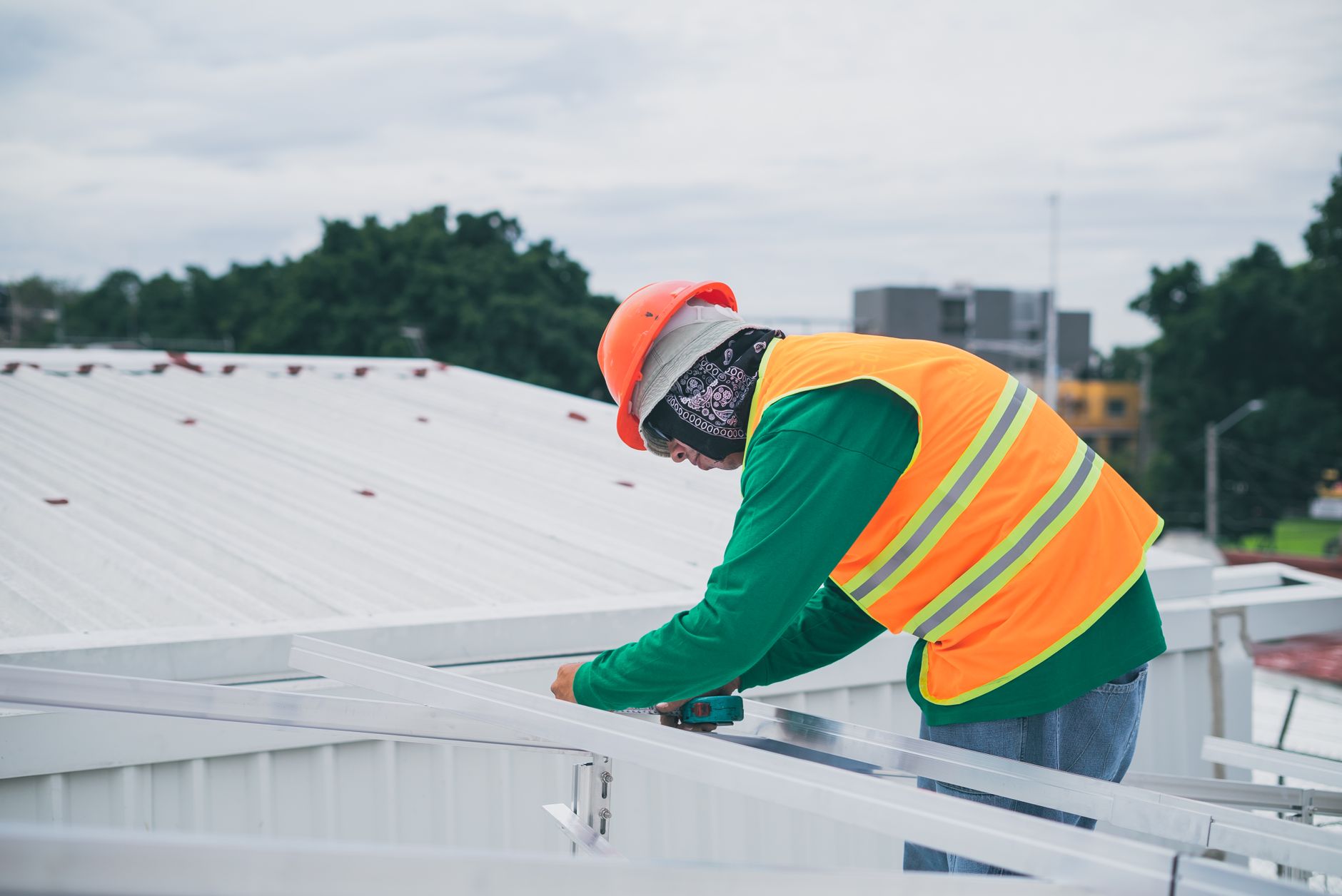 A professional roofing inspector from Storm Guard Roofing examining a tile roof in Spring Valley, Nevada, with the Las Vegas Valley in the background.